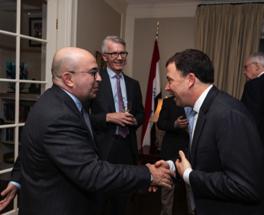 Andrew Marble meeting Mr. Hussein Demirji as Covington's Stephen G. Rademaker looks on.